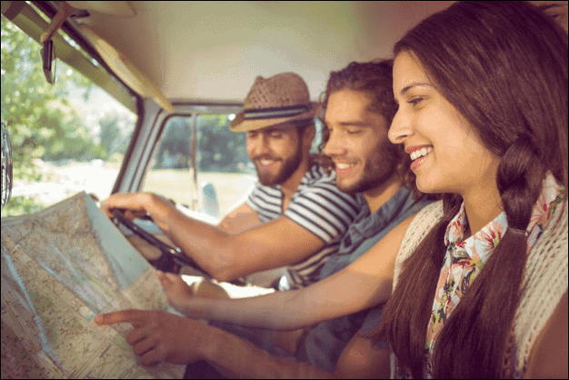 Friends on a Road Trip Looking at a Map.