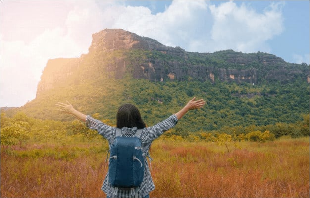 Woman Backpacker on Mountain.