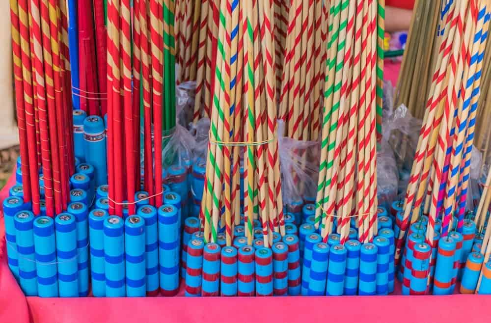 Bundles of rocket fireworks on display at a store.