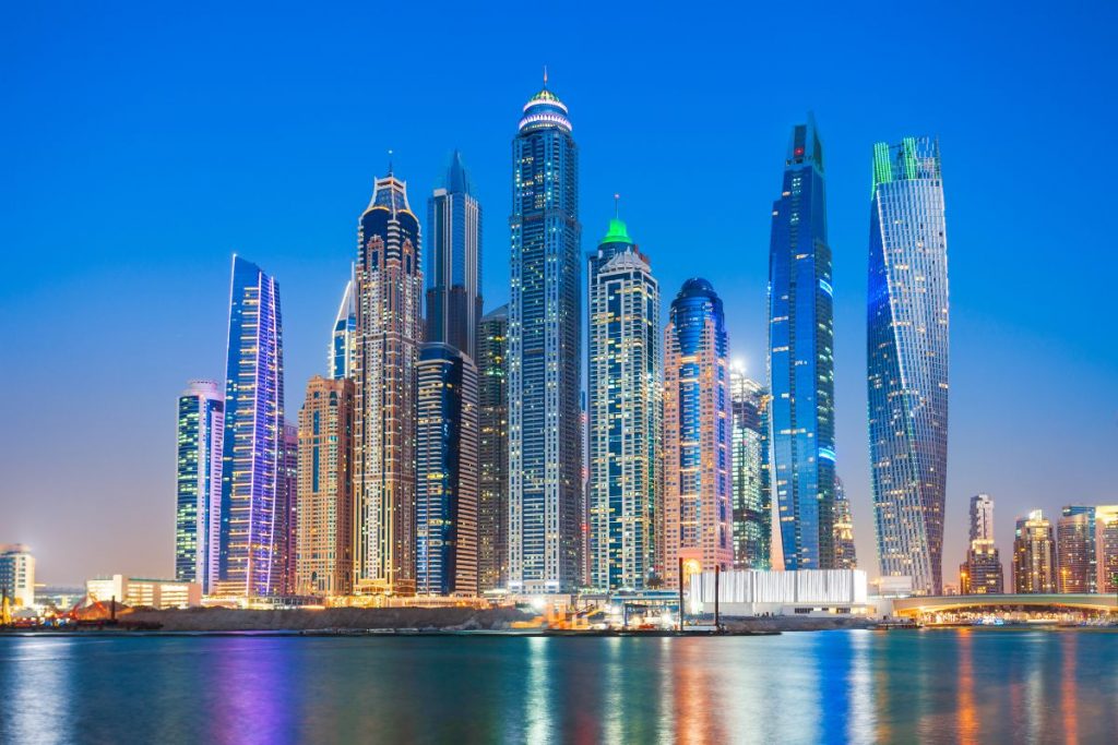 Colorful building and harbor of a city at night time